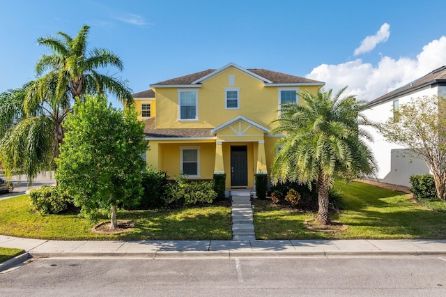 view of front of home featuring a front lawn and stucco siding