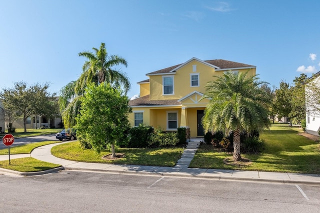 view of front of house featuring a front yard and stucco siding