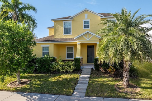 1000 Seburn Rd, Apopka, FL 32703 - traditional-style house featuring stucco siding, roof with shingles, and a front lawn