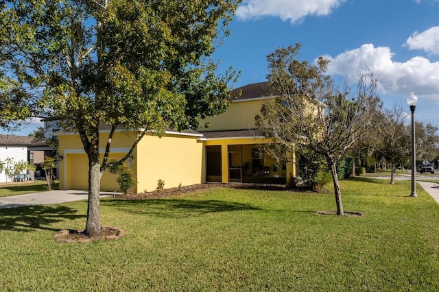 1000 Seburn Rd, Apopka, FL 32703 - view of front facade featuring a front lawn, driveway, stucco siding, and a garage
