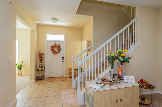 1000 Seburn Rd, Apopka, FL 32703 - foyer featuring stairs, light tile patterned flooring, and baseboards