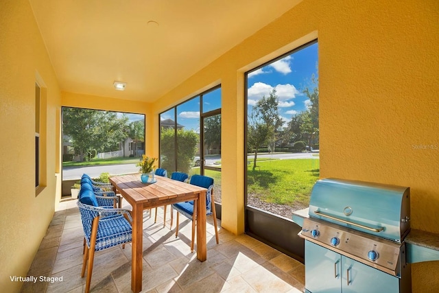 1000 Seburn Rd, Apopka, FL 32703 - sunroom / solarium with a textured wall and stone tile flooring