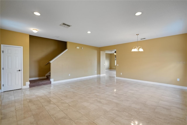 empty room with recessed lighting, visible vents, stairway, baseboards, and ceiling fan with notable chandelier