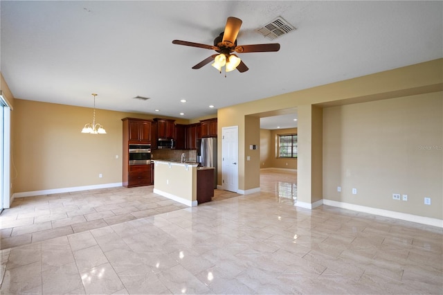 kitchen featuring ceiling fan with notable chandelier, stainless steel appliances, visible vents, baseboards, and open floor plan