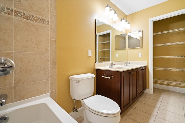 bathroom with toilet, tile patterned flooring, baseboards, and a sink