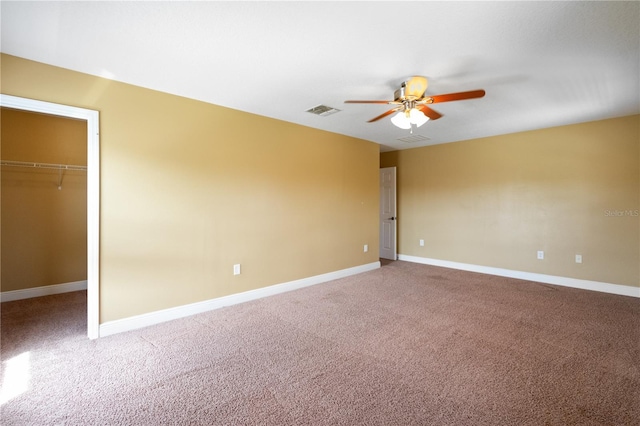 unfurnished room with a ceiling fan, carpet, visible vents, and baseboards