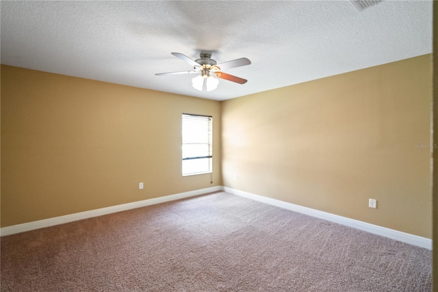 unfurnished room featuring a ceiling fan, carpet flooring, a textured ceiling, and baseboards