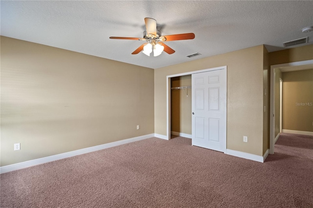 unfurnished bedroom featuring carpet floors, baseboards, visible vents, and a closet