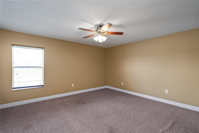 unfurnished room with a textured ceiling, carpet, a ceiling fan, and baseboards