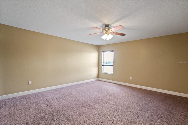 carpeted spare room featuring ceiling fan, a textured ceiling, and baseboards