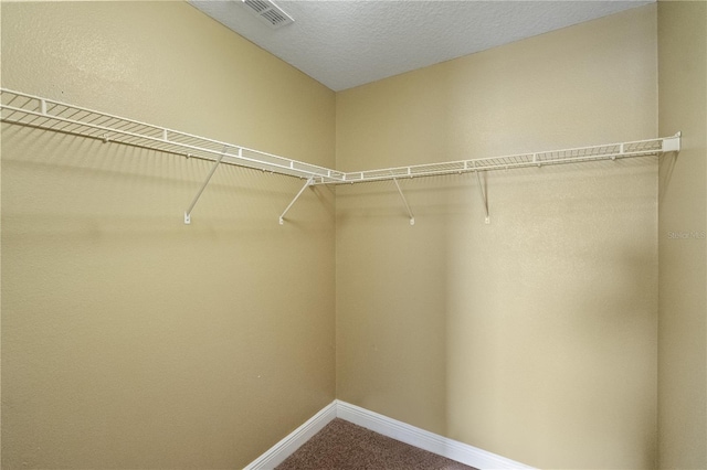 walk in closet featuring carpet flooring and visible vents