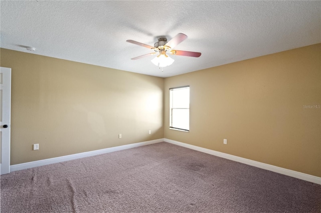 spare room with carpet floors, a textured ceiling, baseboards, and a ceiling fan