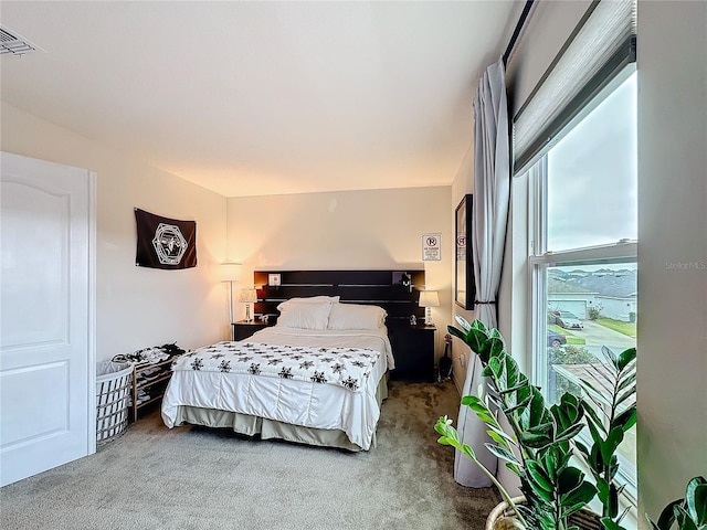 carpeted bedroom with visible vents