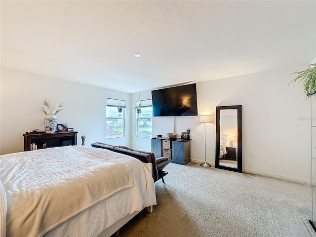 carpeted bedroom with baseboards