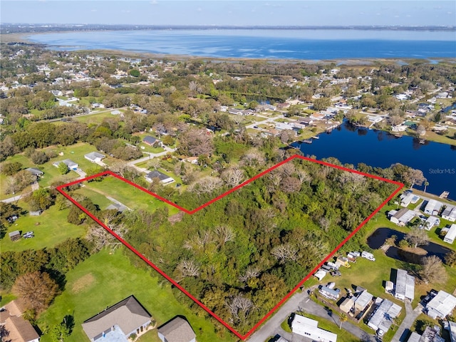 drone / aerial view featuring a water view and a residential view