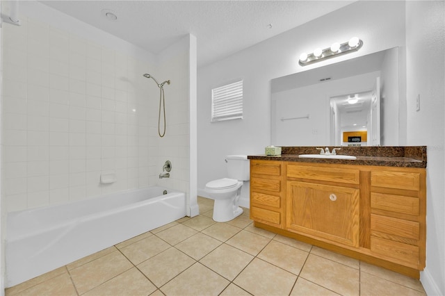 full bath featuring toilet, tile patterned flooring, a textured ceiling, vanity, and washtub / shower combination