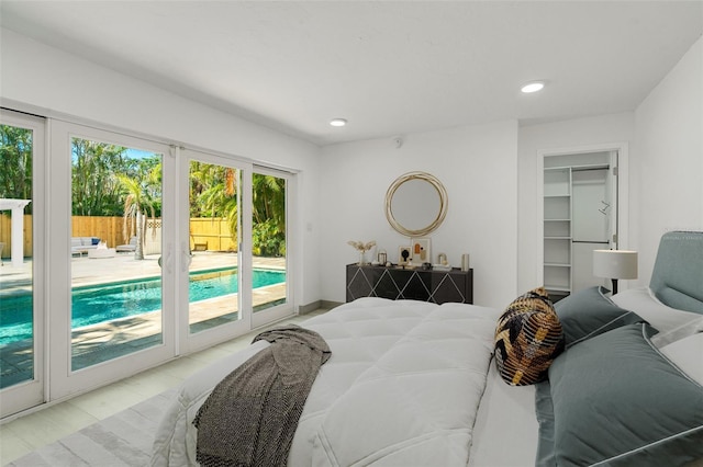 bedroom with access to exterior, recessed lighting, and a spacious closet