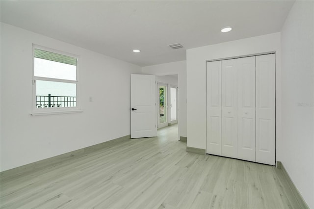 unfurnished bedroom with recessed lighting, visible vents, baseboards, a closet, and light wood-type flooring