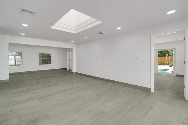 unfurnished room with recessed lighting, visible vents, light wood-style flooring, and baseboards