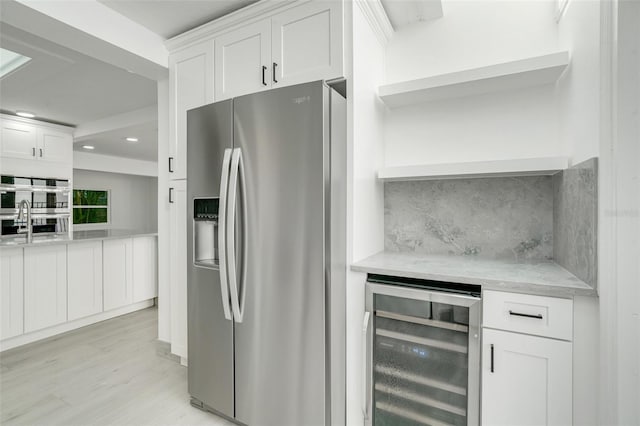 kitchen with wine cooler, white cabinets, appliances with stainless steel finishes, open shelves, and tasteful backsplash