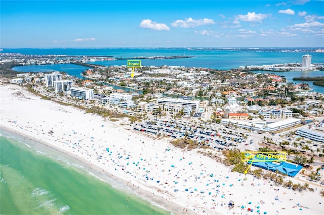 bird's eye view featuring a water view and a beach view