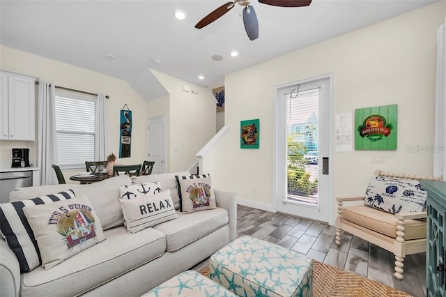 living area with baseboards, recessed lighting, a ceiling fan, and light wood-style floors