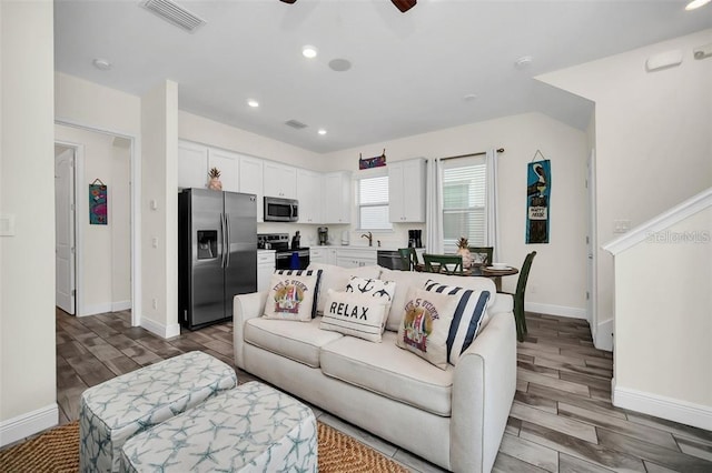 living area featuring ceiling fan, recessed lighting, visible vents, and wood tiled floor