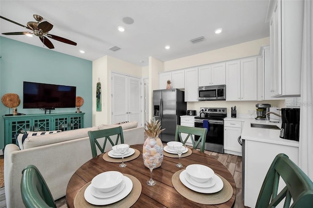 dining room featuring ceiling fan, visible vents, light wood-style flooring, and recessed lighting