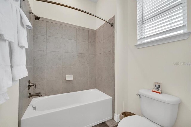 bathroom with toilet and shower / bath combination