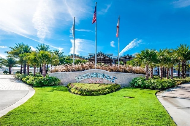 community sign featuring a lawn