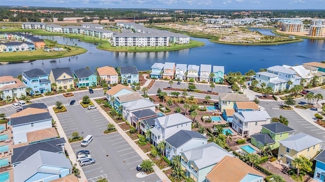 birds eye view of property featuring a water view and a residential view