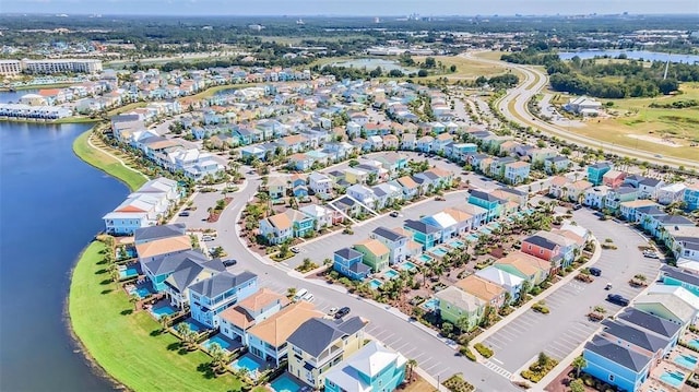 birds eye view of property with a water view and a residential view