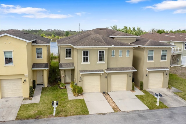 multi unit property with a shingled roof, driveway, an attached garage, and stucco siding