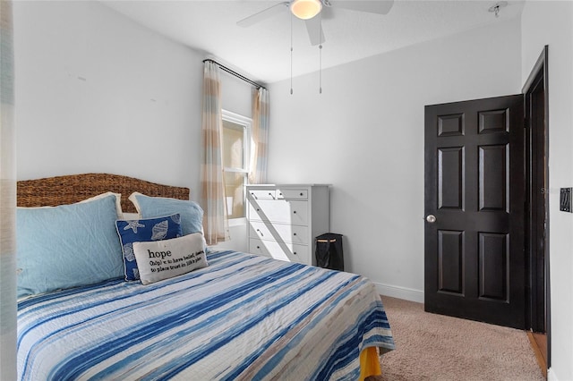 carpeted bedroom with ceiling fan and baseboards