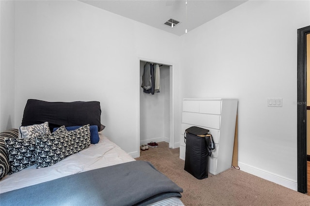 bedroom with baseboards, a closet, visible vents, and carpet flooring