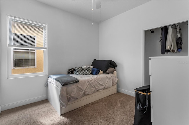 carpeted bedroom featuring baseboards