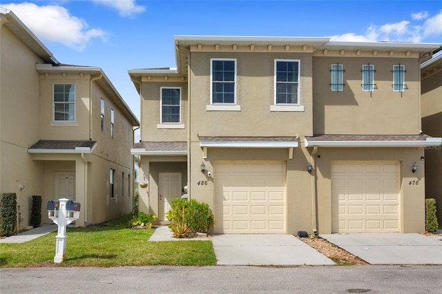 view of property featuring driveway, an attached garage, and stucco siding