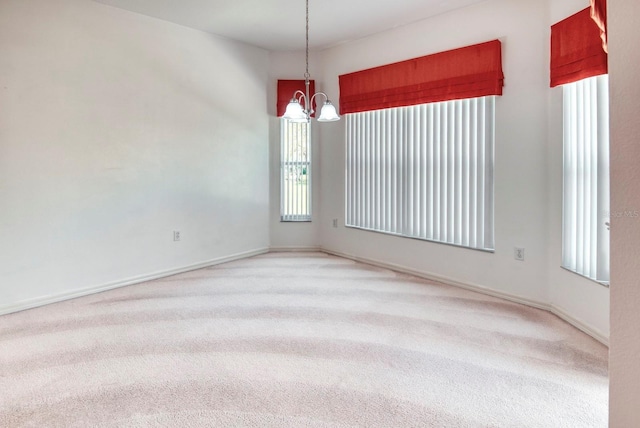 153 Ventana Dr, Poinciana, FL 34759 - spare room featuring light colored carpet, baseboards, and an inviting chandelier