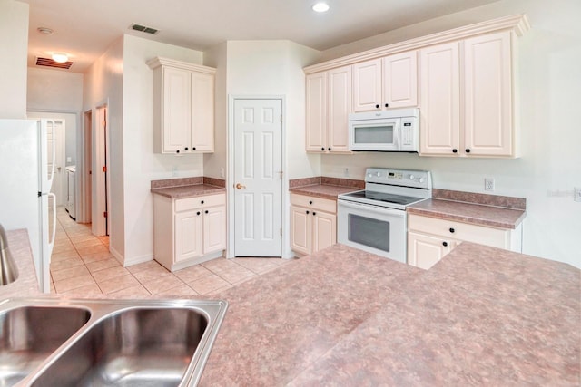 153 Ventana Dr, Poinciana, FL 34759 - kitchen featuring visible vents, a sink, recessed lighting, white appliances, and light tile patterned floors
