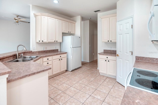 153 Ventana Dr, Poinciana, FL 34759 - kitchen with white appliances, a ceiling fan, visible vents, a peninsula, and a sink