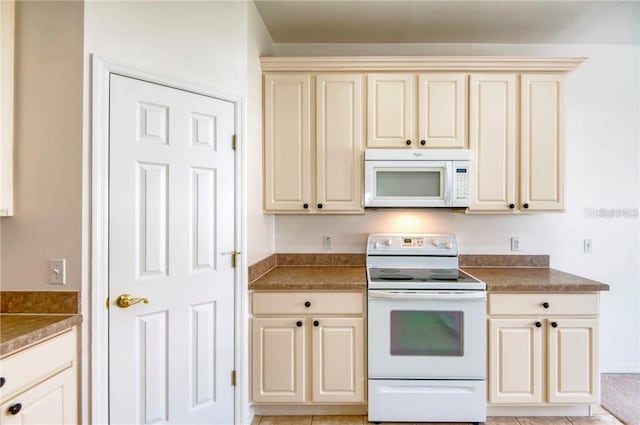 153 Ventana Dr, Poinciana, FL 34759 - kitchen with white appliances, cream cabinets, and dark countertops