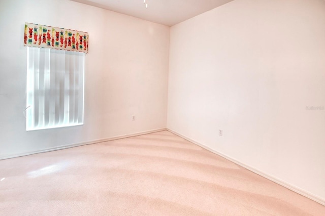 153 Ventana Dr, Poinciana, FL 34759 - spare room with baseboards, light carpet, and a ceiling fan