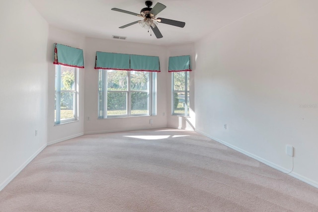 153 Ventana Dr, Poinciana, FL 34759 - empty room with a ceiling fan, light colored carpet, visible vents, and baseboards