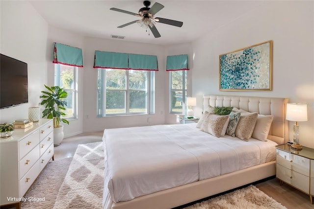 153 Ventana Dr, Poinciana, FL 34759 - bedroom with visible vents, light wood-style floors, and a ceiling fan