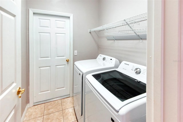 153 Ventana Dr, Poinciana, FL 34759 - laundry area featuring laundry area, light tile patterned flooring, and washer and clothes dryer