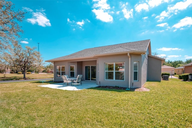 153 Ventana Dr, Poinciana, FL 34759 - back of property featuring a yard, a patio area, and stucco siding