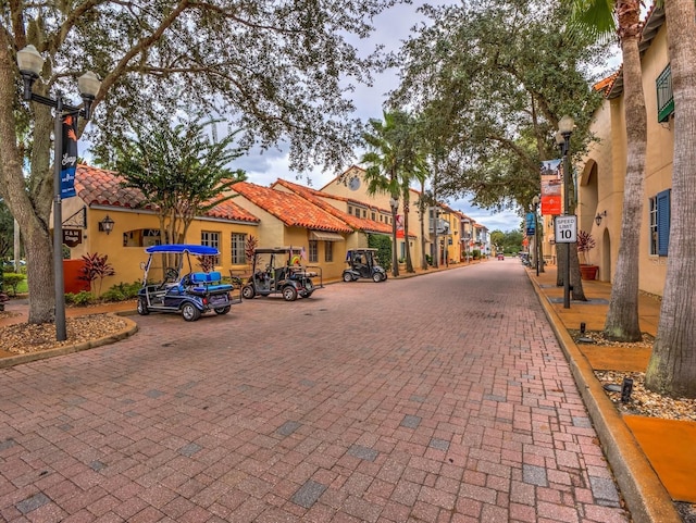 153 Ventana Dr, Poinciana, FL 34759 - view of street featuring curbs, street lights, and traffic signs