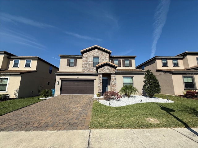 view of front of house featuring a front yard, stucco siding, decorative driveway, a garage, and stone siding