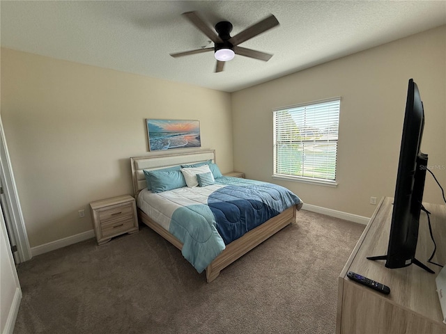 bedroom featuring a textured ceiling, baseboards, carpet, and a ceiling fan