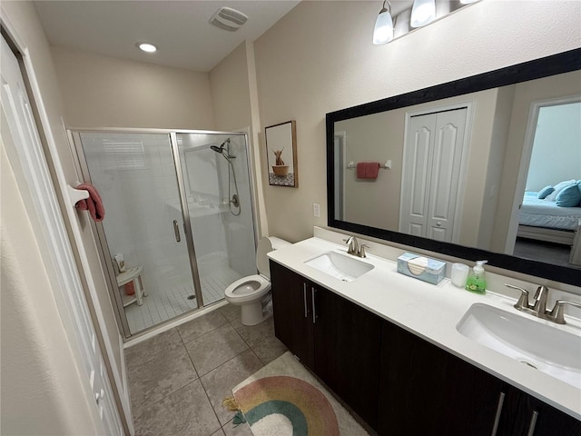 full bath featuring a sink, toilet, a stall shower, and tile patterned floors